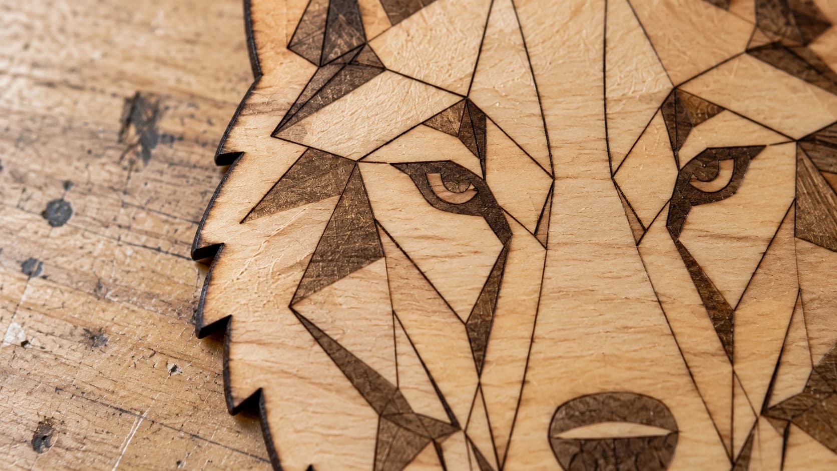 Close view of the same geometric wolf ornament with engraved facial details
