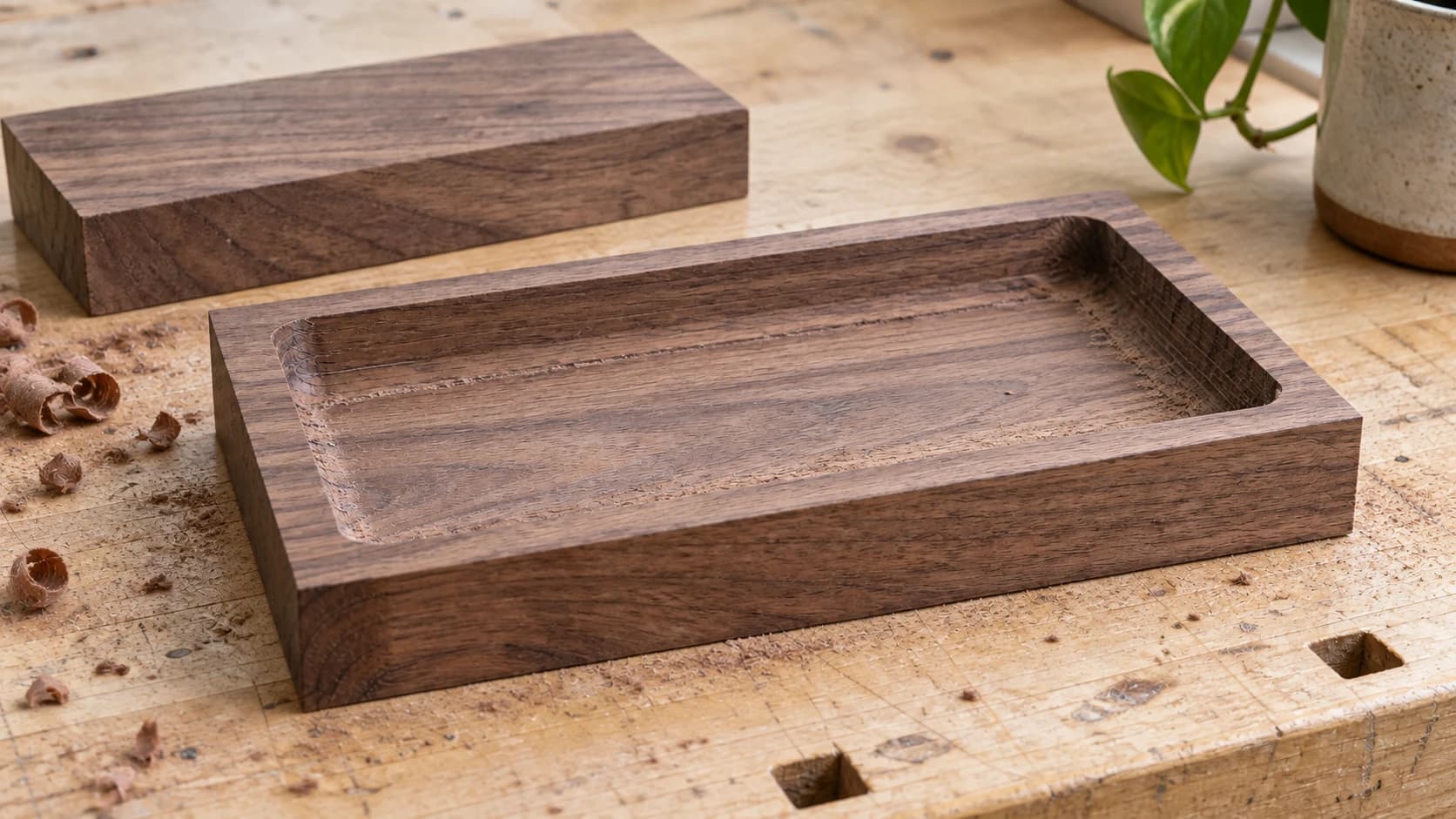 The walnut tray pocket machined into rectangular stock before the outside profile is rounded