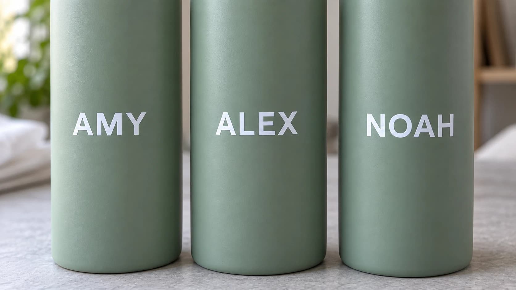 White names aligned across three matching sage water bottles