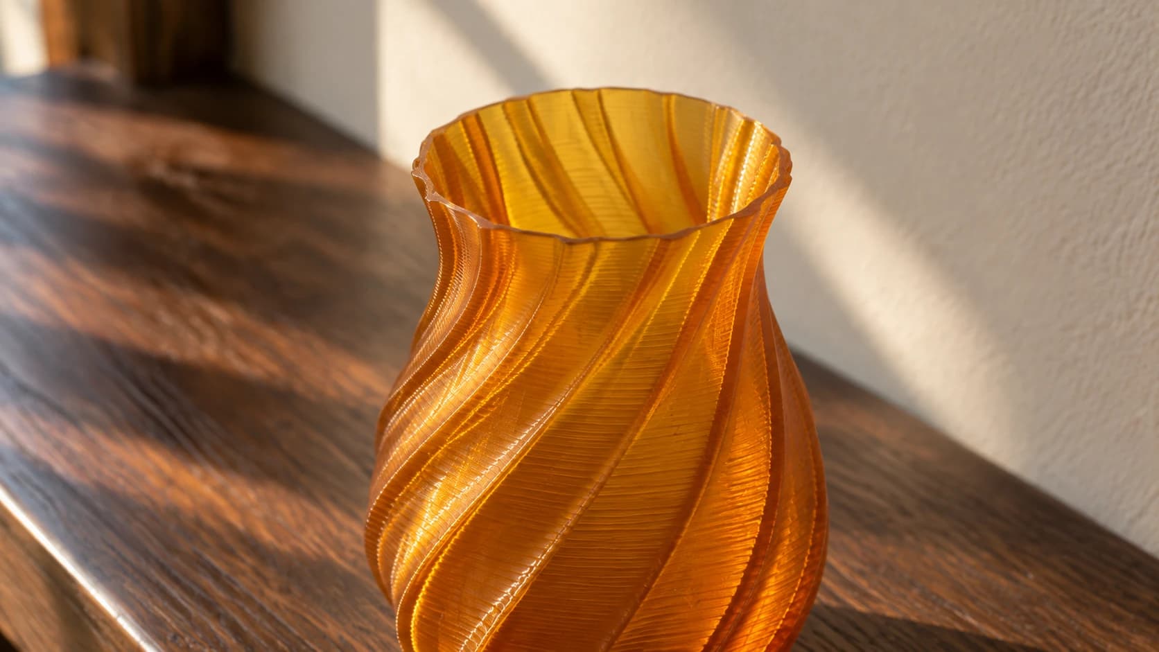 Close view into the amber printed vase showing its thin continuous rim and hollow interior
