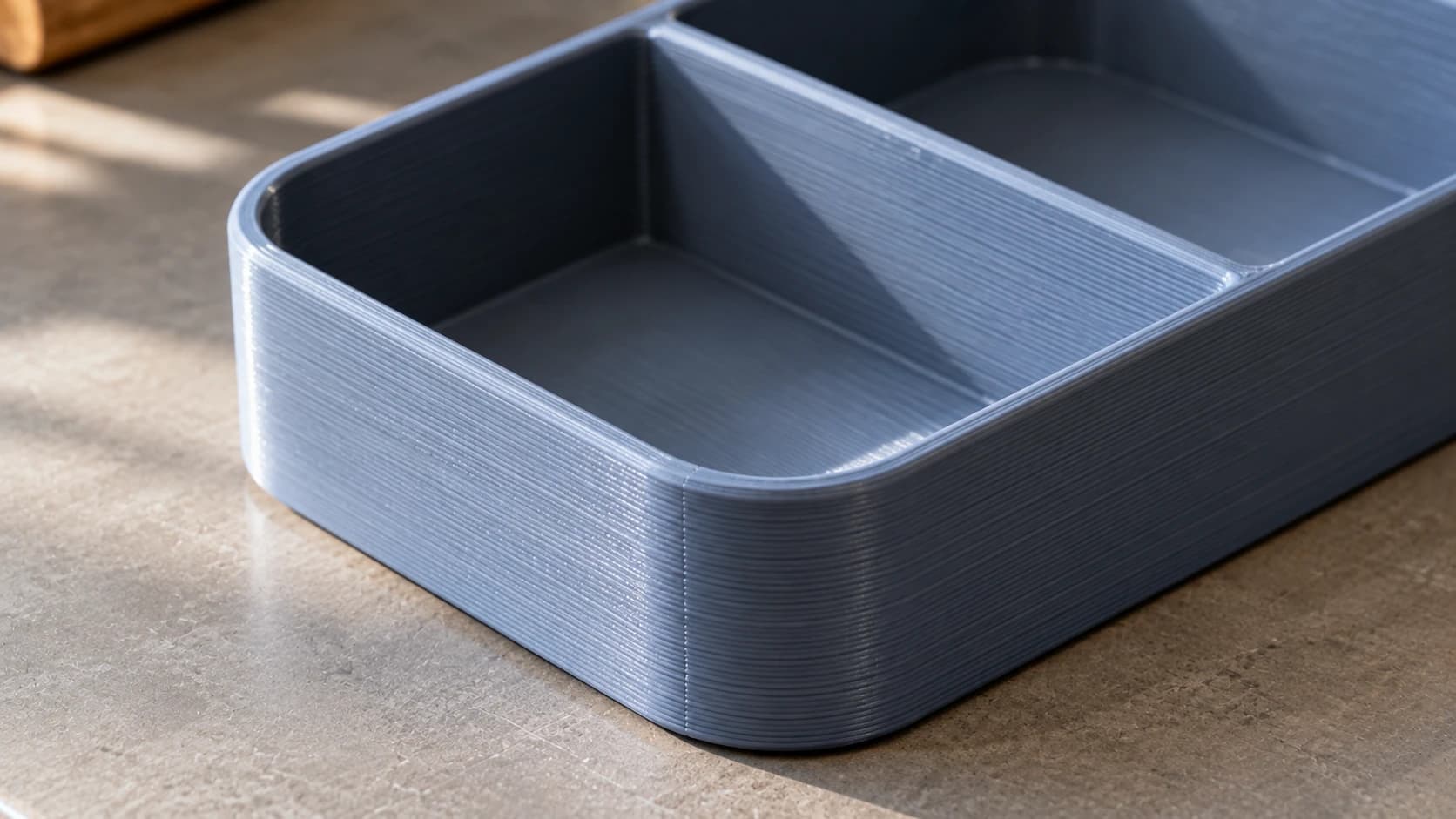 Close view of the same slate-blue printed tray with visible layers and a joined divider