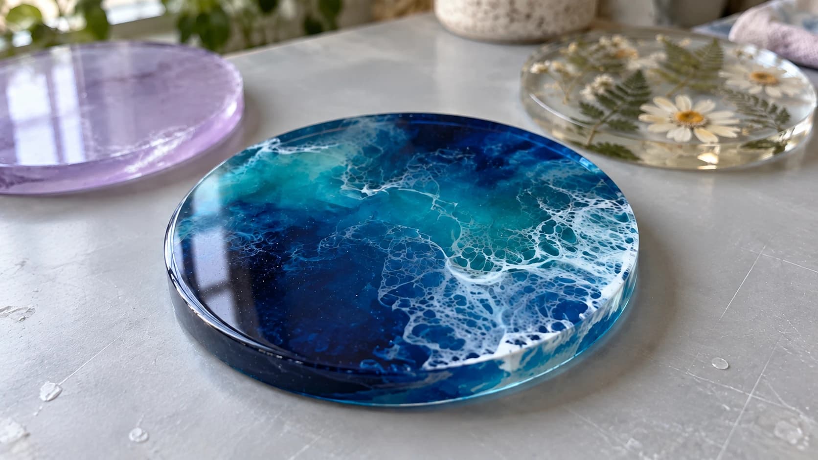 Close view of the blue resin coaster with thin white lacing across its smooth cured surface