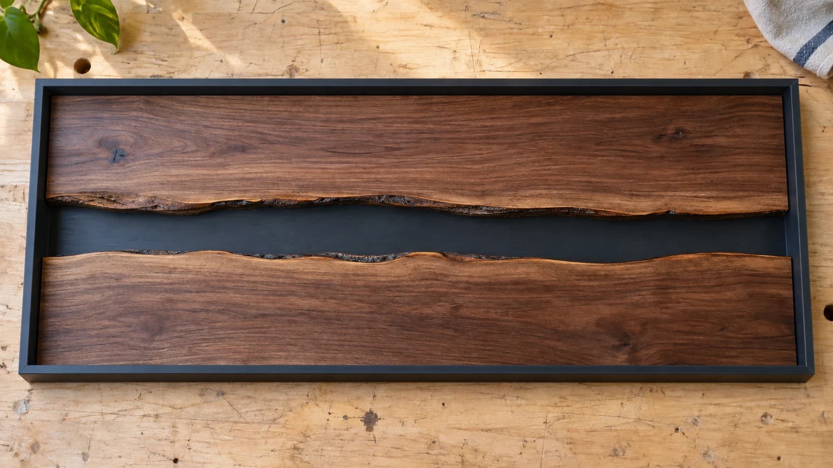 Two matching walnut planks dry-fitted in a rectangular mold with an empty river channel between them